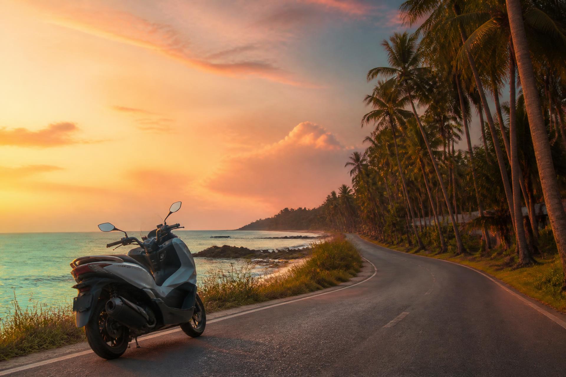 Scooter on a coastal road at sunset in Khao Lak, Thailand